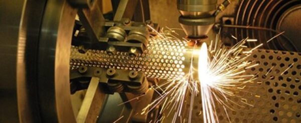 A machine cutting metal with sparks flying.