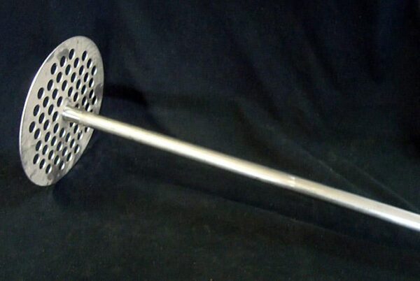 A metal object with a long handle on top of it.