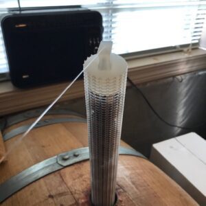 A tube of glue sitting on top of a wooden table.