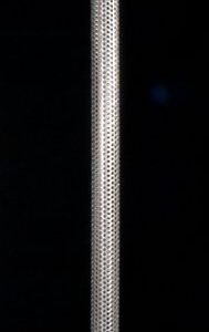 A metal pole with a black background