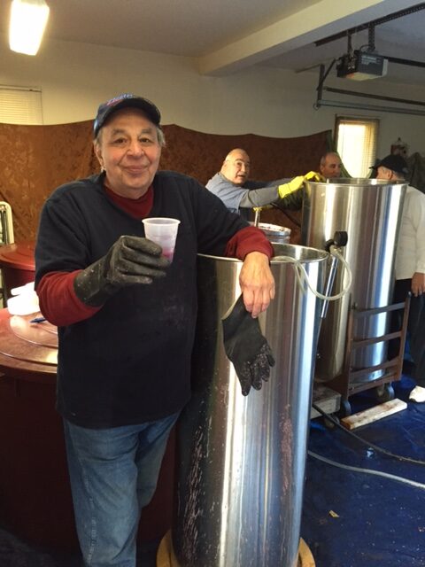 A man holding a cup in his hand.